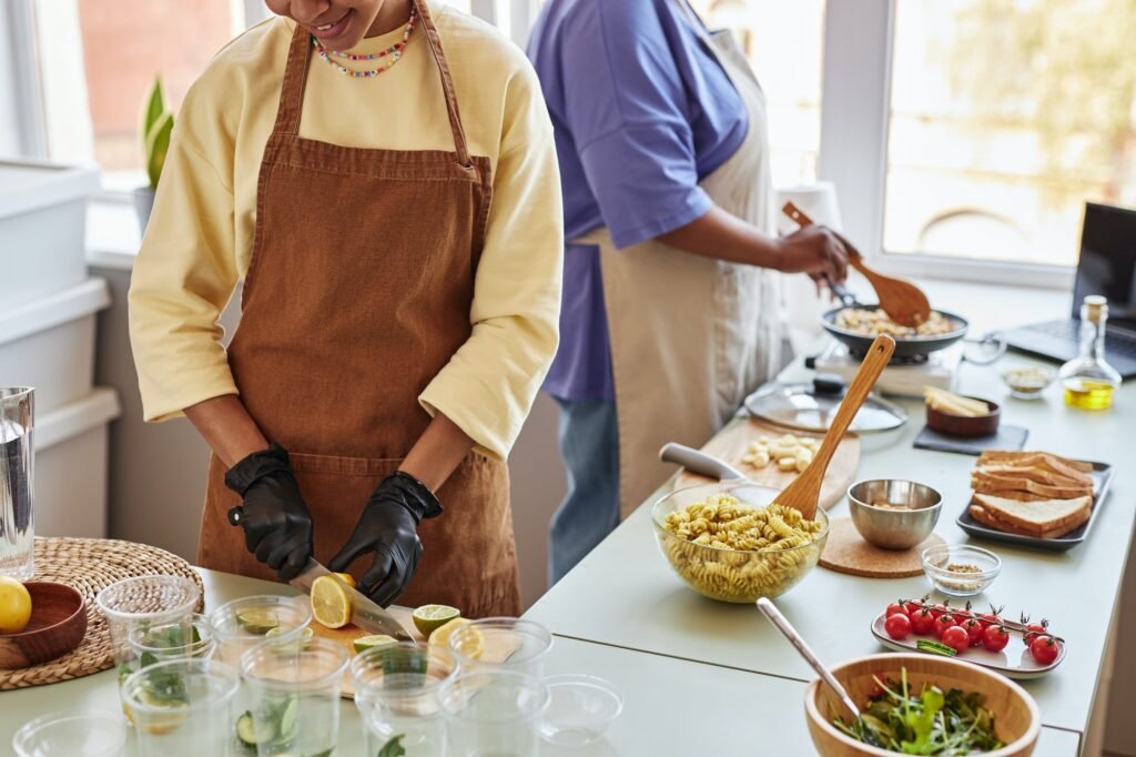 Two African American women doing food prep in kitchen